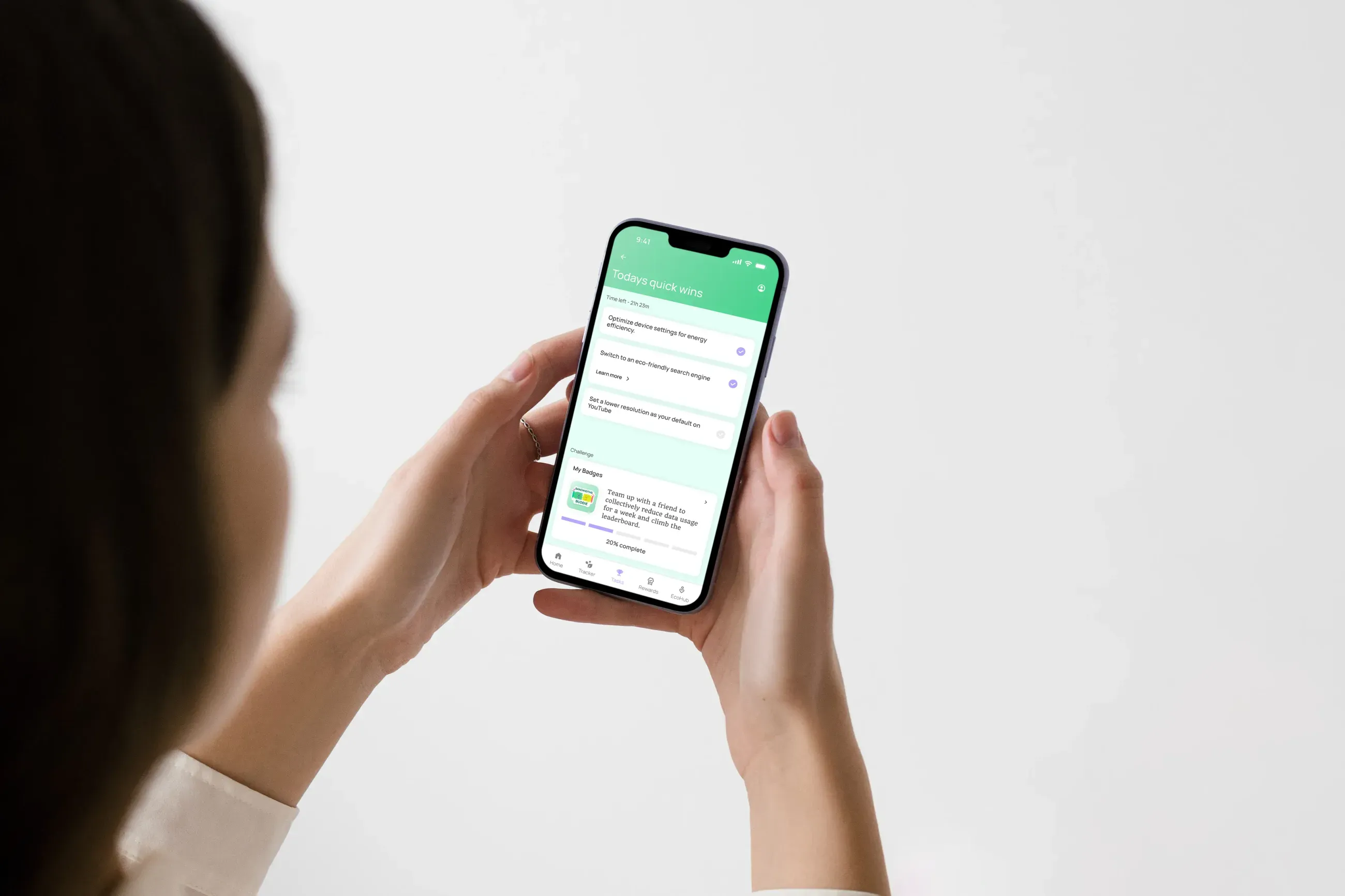 Person holding a phone showing the EcoByte app